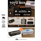 Promotional graphic for the Go Toyo Box Field Coffee Kit, showing a black hard case with a brown handle, included accessories, and packaging on a wood background with feature callouts and icons.