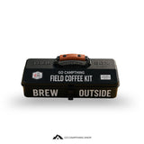 A black metal coffee kit box with a brown leatherette handle, featuring white text that reads 'GO CAMPTHING FIELD COFFEE KIT' and 'BREW OUTSIDE'.